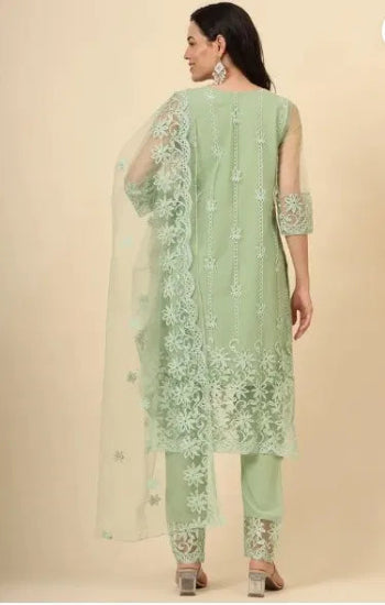 Light green embroidered traditional outfit on a beige background