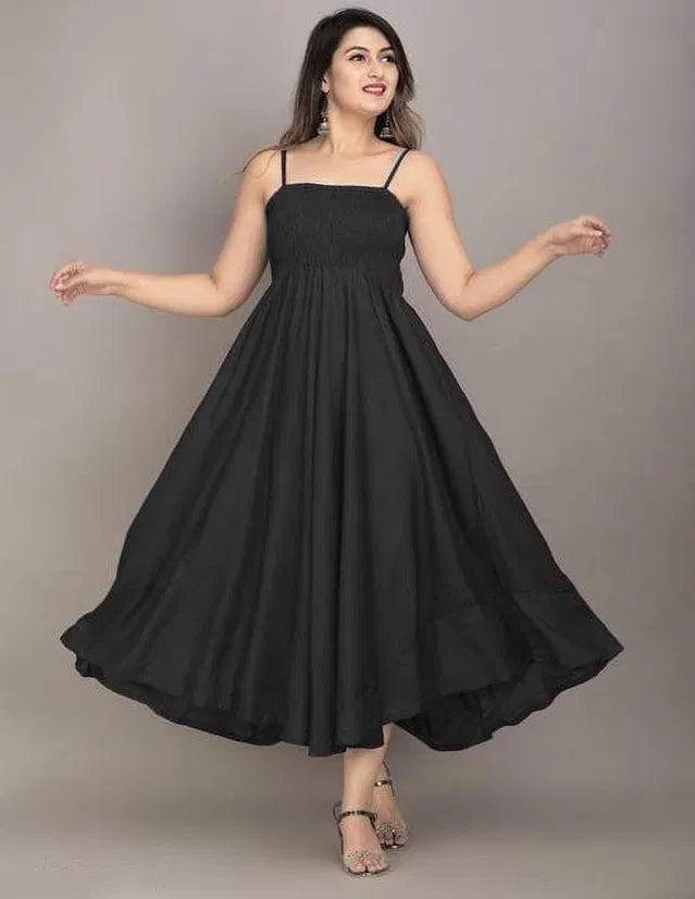 Woman wearing a black dress against a plain background